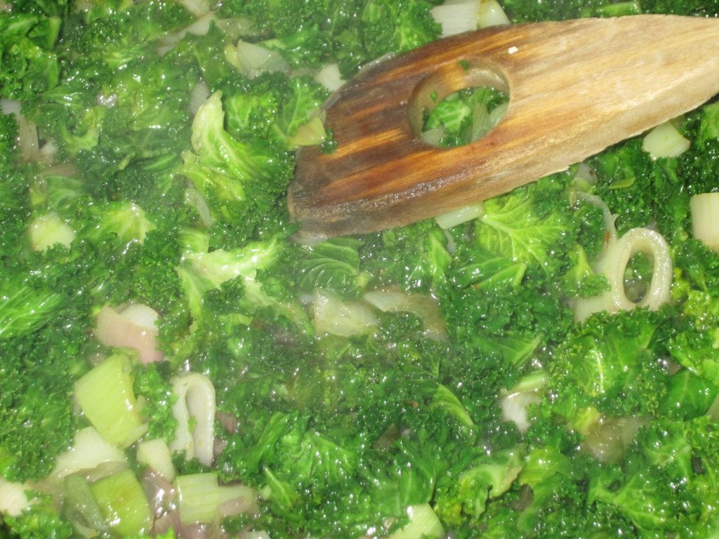 Once the desired level of carmelization has been reached add the chopped chard leaves and saute stirring occasionally until they are bright green.