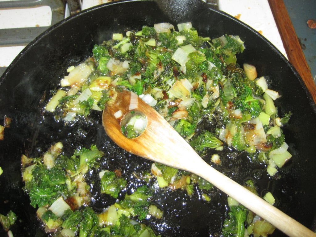Dice up an onion and saute in oil (I used olive). strip the chard leaves from the stalks, dice up the stalks and carmelize them as well.
