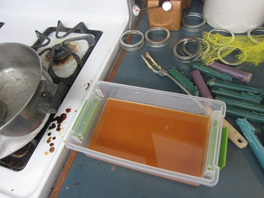 Carefully pour the hot wax into the tray. I used a pair of tongs to hold the hot coffee can. The wax is about an inch thick and I will give it a day or so to harden completely.
