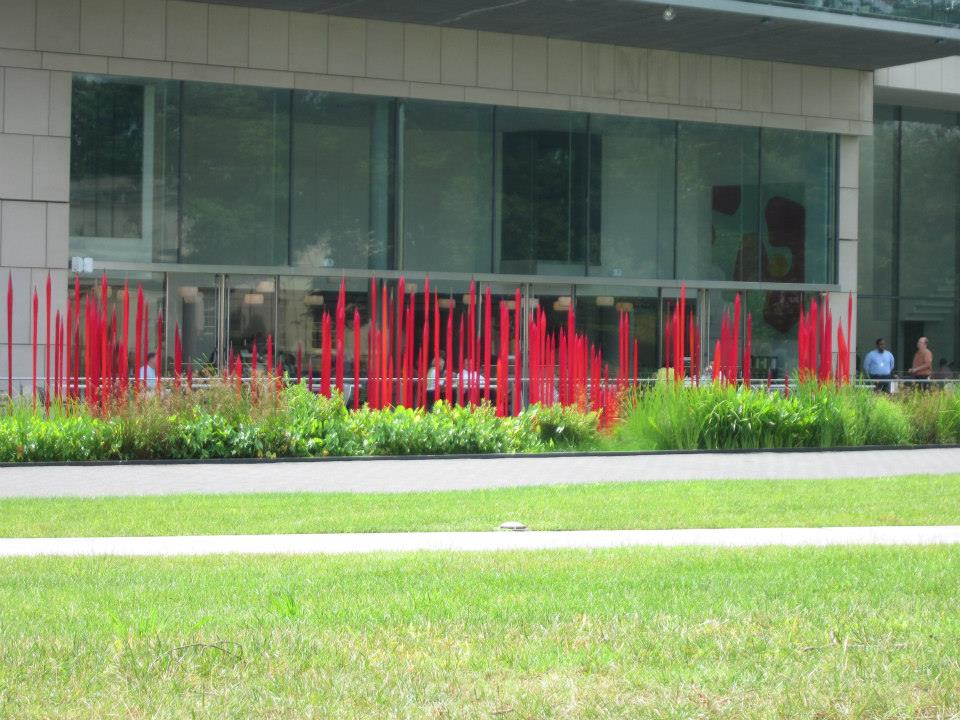 Those red things are blown glass "reeds" planted in the reflecting pool.